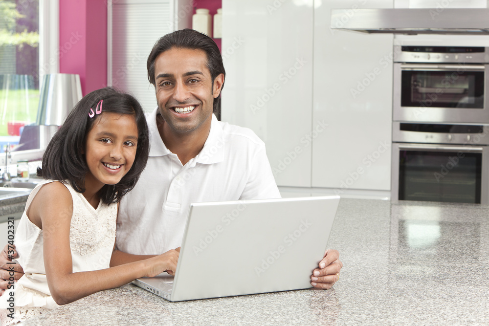 Asian Indian Father & Daughter Using Laptop Computer at Home Asian Indian Father & Daughter Using Laptop Computer at Home