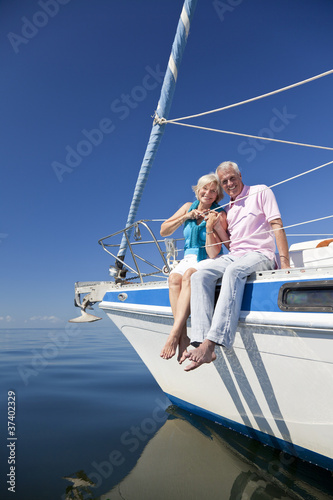 Happy Senior Couple Sitting on a Sail Boat