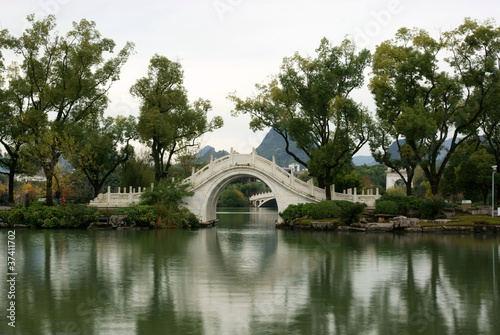 Arch bridge in chinese park photo