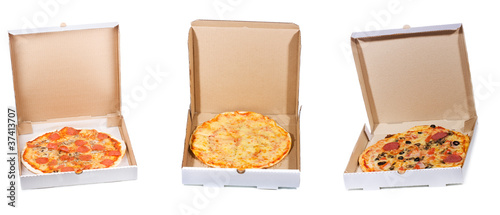 set with different pizza in open paper box