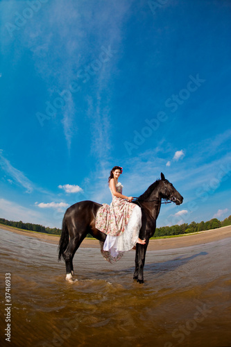 Woman on a horse by the sea