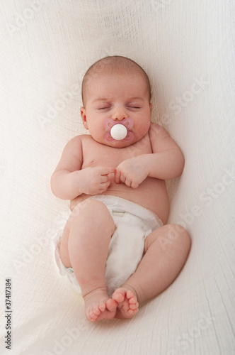 Newborn Baby sleeping on a white background.