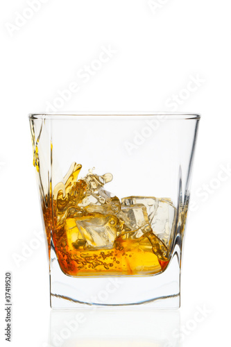 Whiskey glass. Isolated on white with reflection