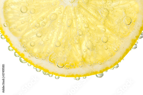 Bubbles on a lemon segment in soda water