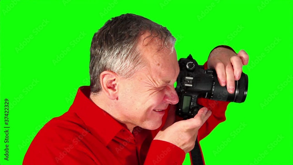 Close-up photographer on a green screen