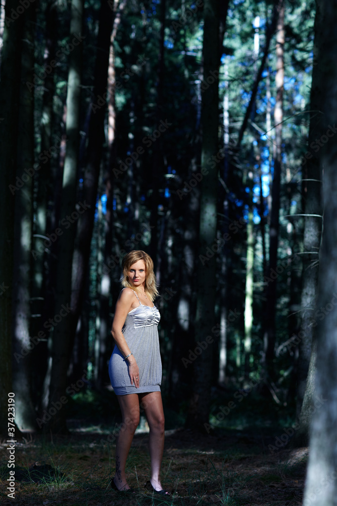 junge modische Frau posiert im Wald