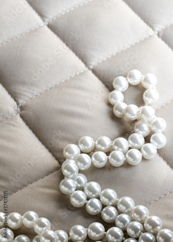 String of pearls on a gray fabric