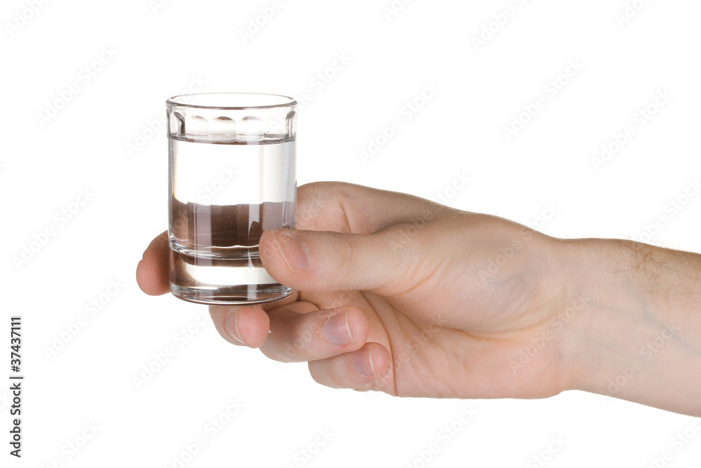 Man's hand holding a glass with vodka isolated on white Man's hand holding a glass with vodka isolated on white