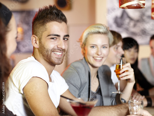 Group of young friends having fun in a pub