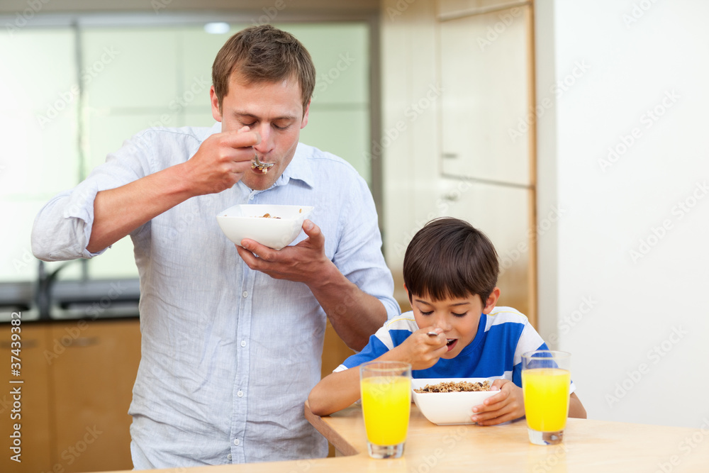 Fototapeta premium Father and son having cereals