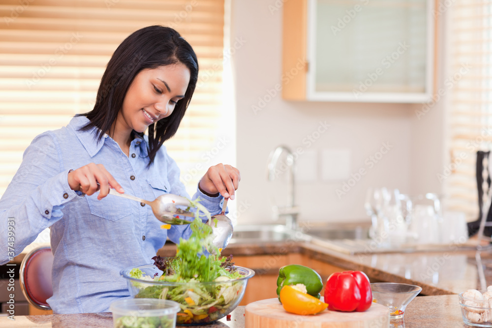 Woman stirring salad