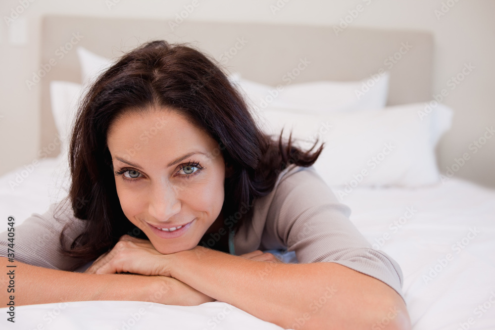 Smiling woman relaxing on the bed Smiling woman relaxing on the bed