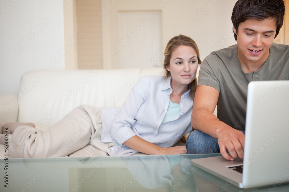 Relaxed couple using a laptop Relaxed couple using a laptop