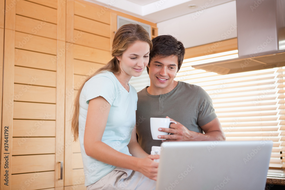 Couple having tea while using a notebook Couple having tea while using a notebook