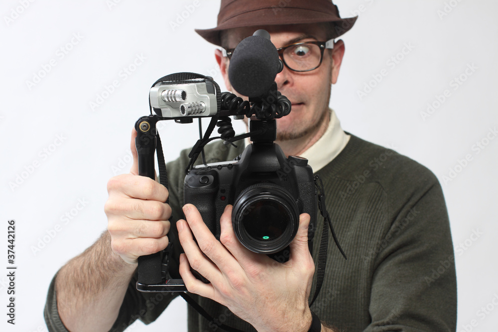 Man with HD SLR camera and audio equipment Man with HD SLR camera and audio equipment