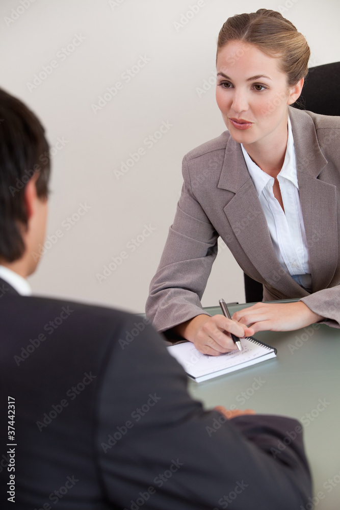 Portrait of a serious manager interviewing a male applicant Portrait of a serious manager interviewing a male applicant