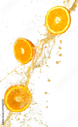 Fresh oranges with juice splash, isolated on white background