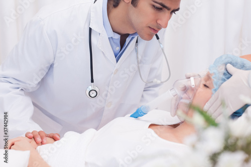 Doctor examining intensive care patient