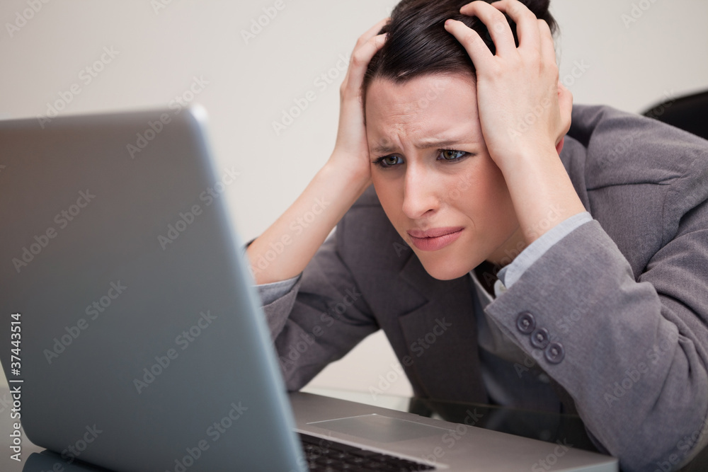Businesswoman having trouble with her notebook Businesswoman having trouble with her notebook