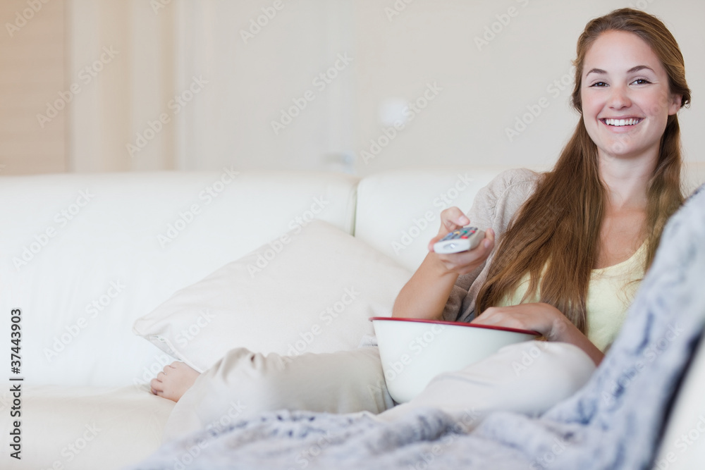 Woman having some popcorn while enjoying a movie Woman having some popcorn while enjoying a movie