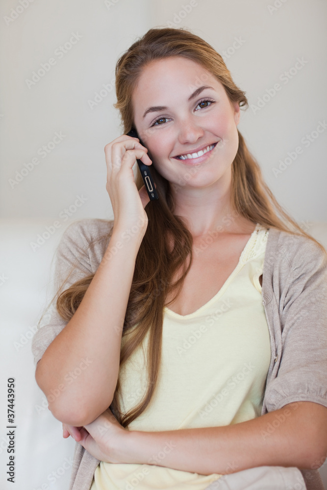 Smiling woman having a conversation on her cellphone Smiling woman having a conversation on her cellphone