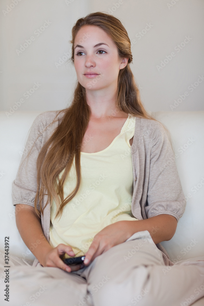 Naklejka premium Woman with cellphone in thoughts