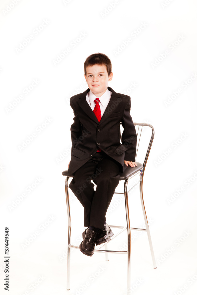 Boy in official dresscode with a cell phone Boy in official dresscode with a cell phone