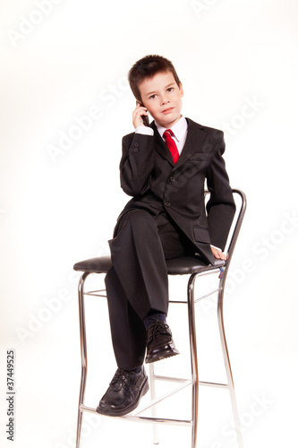 Boy in official dresscode with a cell phone