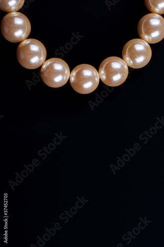 Beige necklace on a black background