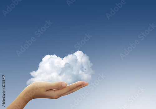 Cloud in woman hands on blue sky