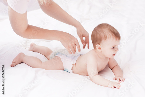 Mother massaging and exercise her little baby