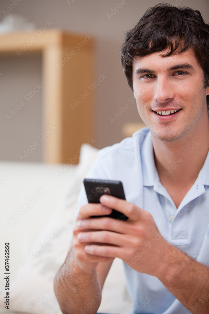 Smiling man with cellphone in his hands Smiling man with cellphone in his hands