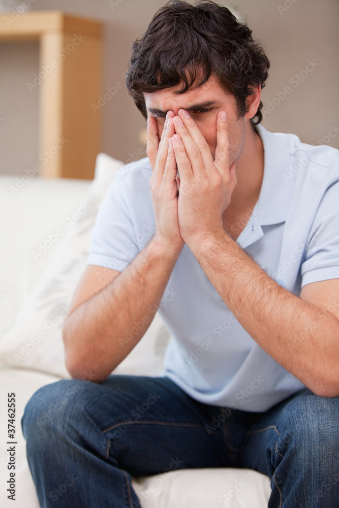 Desperate man sitting on the sofa Desperate man sitting on the sofa