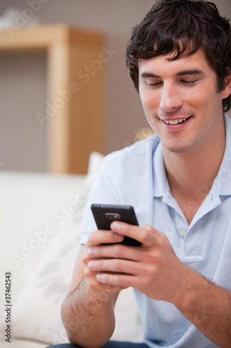 Smiling man writing textmessage