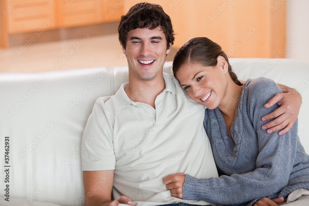 Happy couple enjoying their time together on the sofa Happy couple enjoying their time together on the sofa