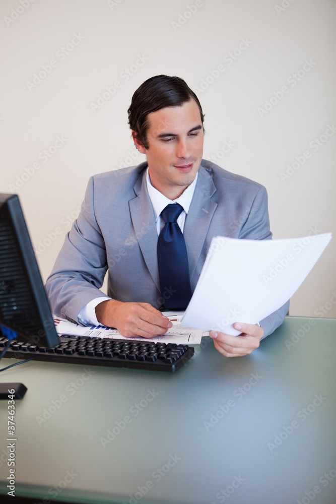 Businessman having a look at a contract Businessman having a look at a contract