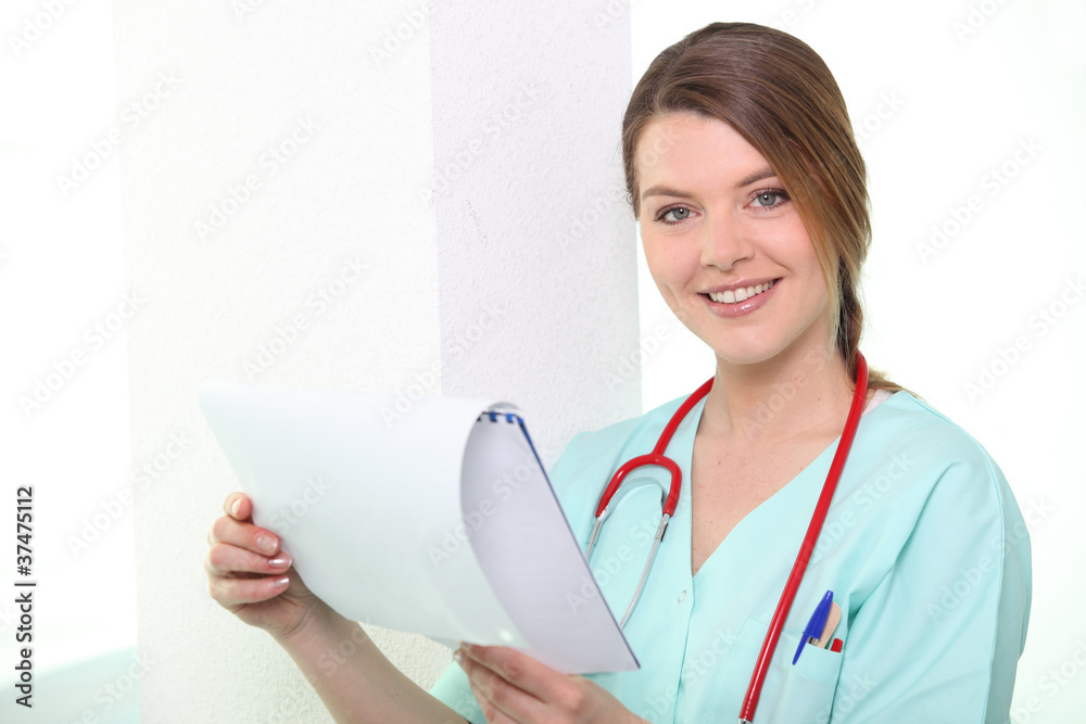 Nurse looking at calendar smiling Nurse looking at calendar smiling