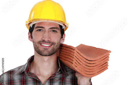 Tradesman holding shingles