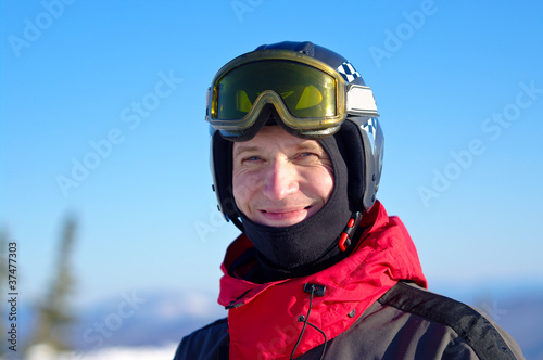 Smiling skier in helmet