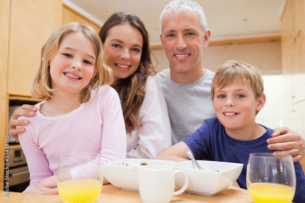 Close up of a smiling family having breakfast Close up of a smiling family having breakfast