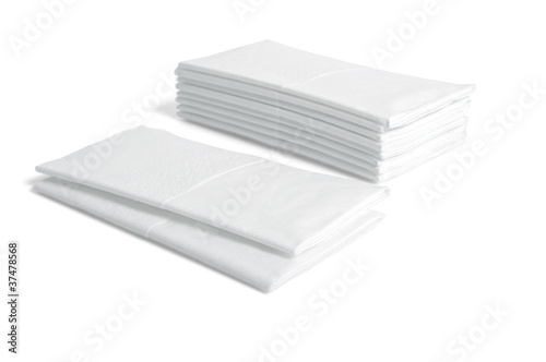 Stacks of folded disposable tissue papers on white background
