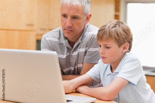 Boy and his father using a laptop © WavebreakmediaMicro