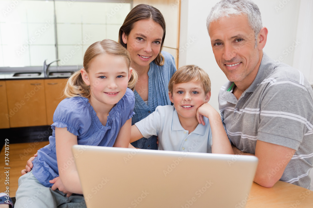 Charming family using a laptop Charming family using a laptop