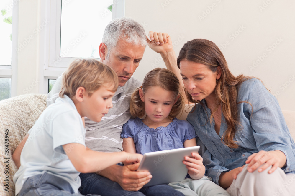 Family using a tablet computer Family using a tablet computer