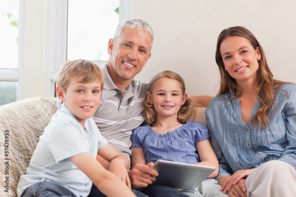 Smiling family using a tablet computer Smiling family using a tablet computer