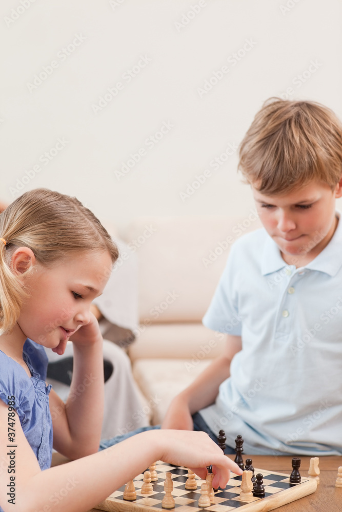 Portrait of siblings playing chess