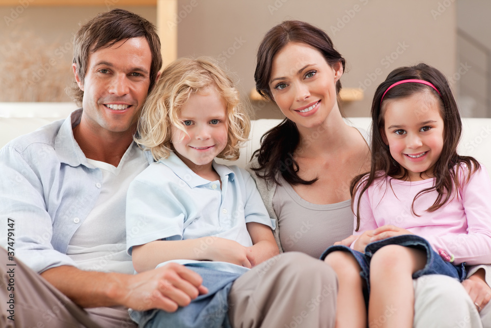 Happy family watching television together Happy family watching television together