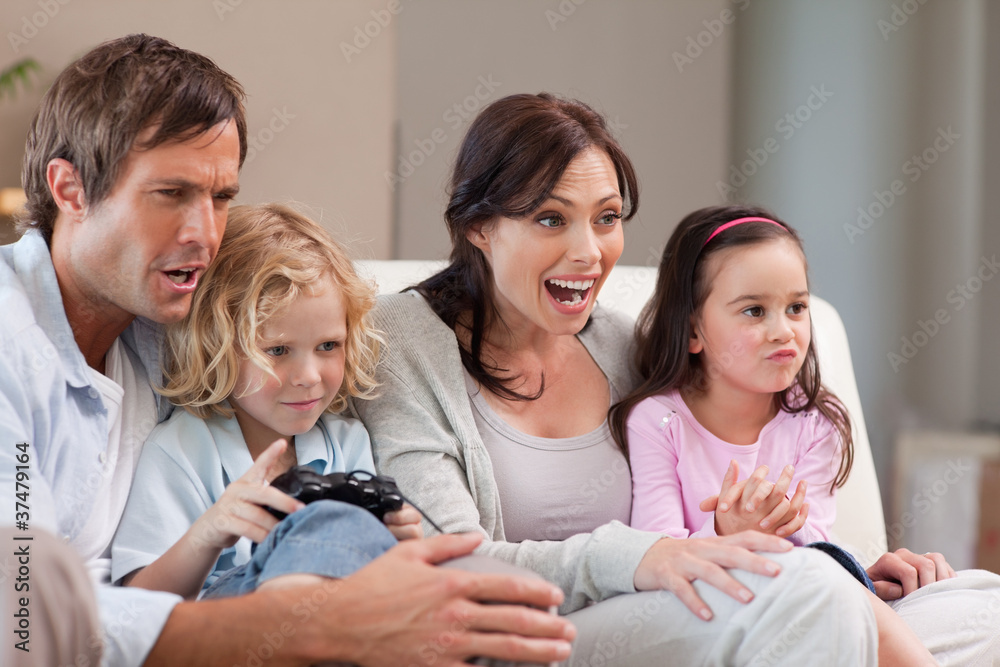 Cheerful family playing video games together Cheerful family playing video games together