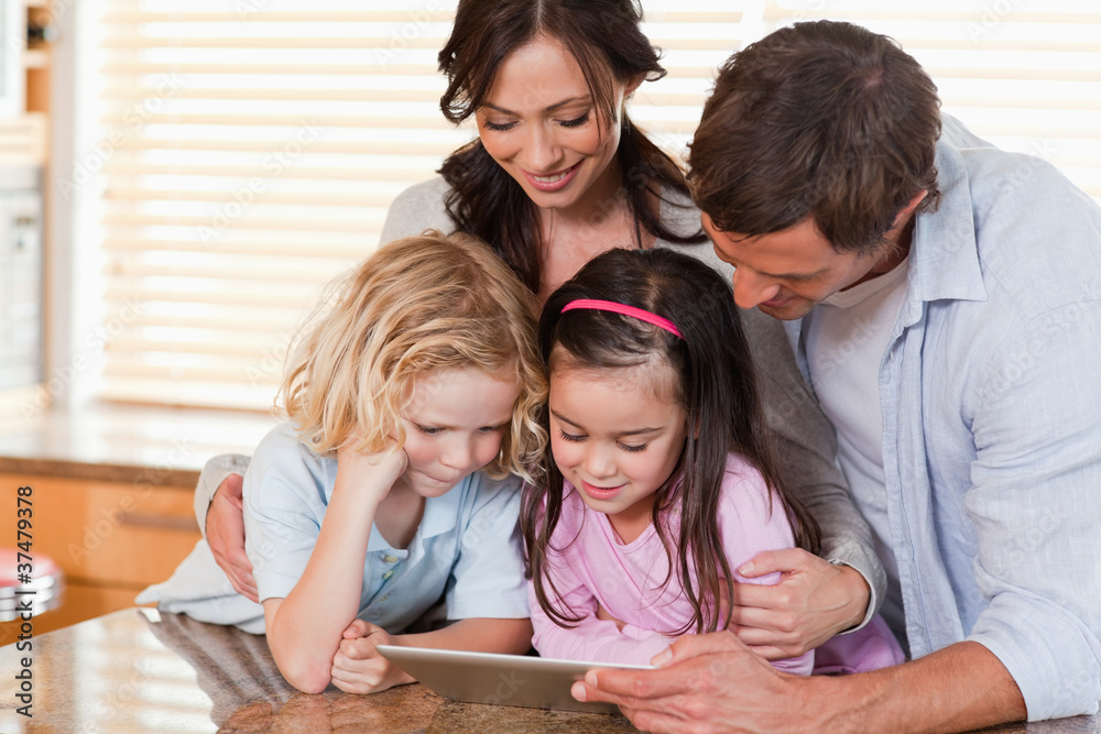 Happy family using a tablet computer together Happy family using a tablet computer together