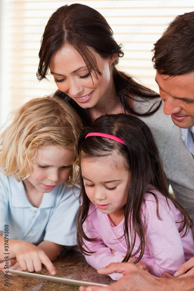 Portrait of a family using a tablet computer together Portrait of a family using a tablet computer together